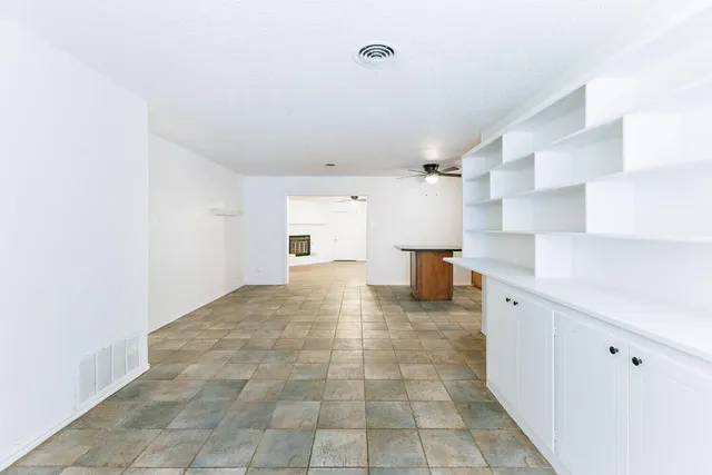 a view of a kitchen with a sink and a refrigerator