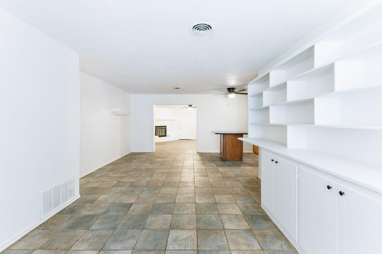 5517 16th Place Lubbock, TX 79416 - Photo 3 of 23 a view of a kitchen with a sink and a refrigerator