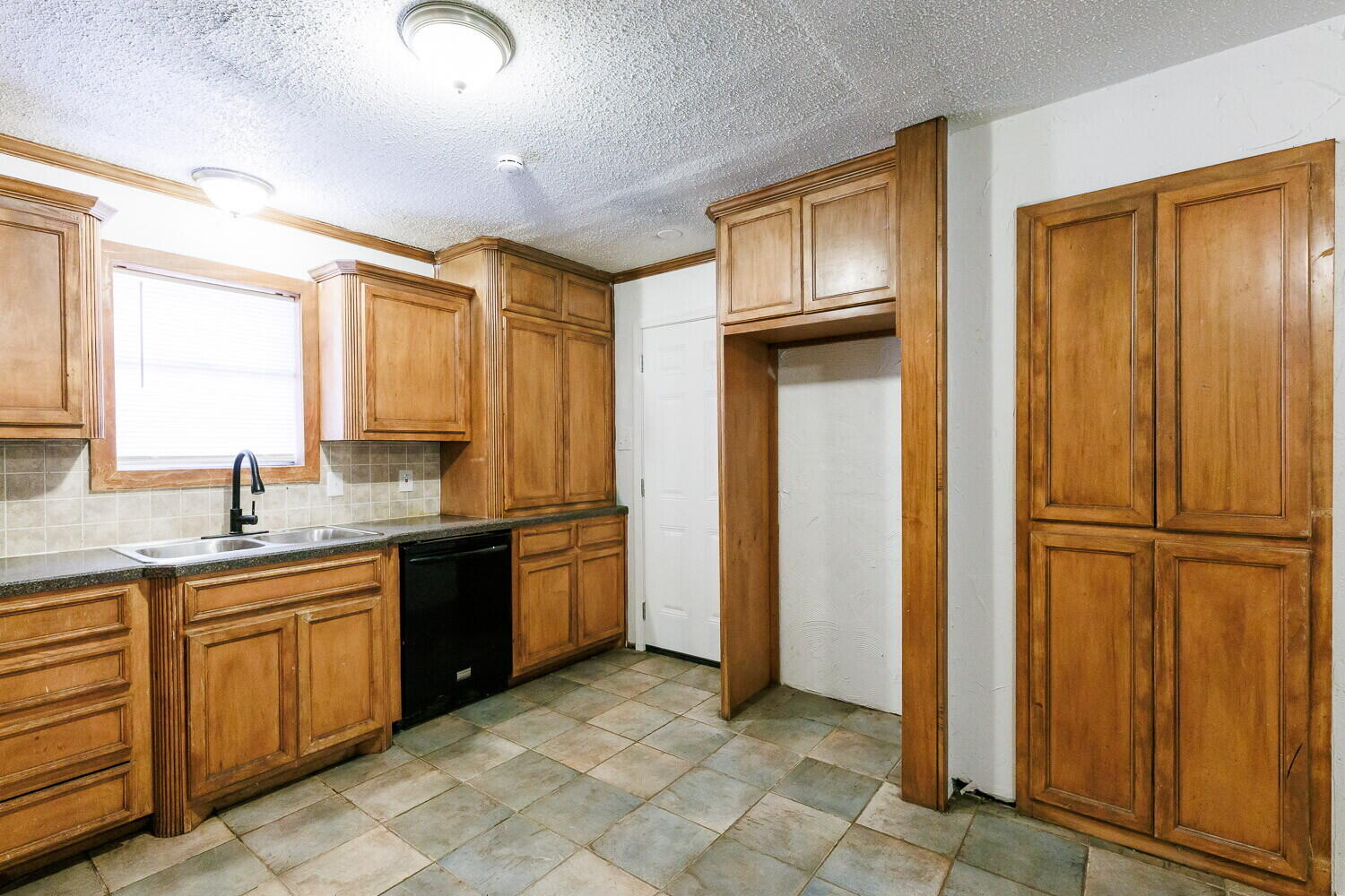 5517 16th Place Lubbock, TX 79416 - Photo 7 of 23 a kitchen with stainless steel appliances granite countertop a refrigerator and a sink