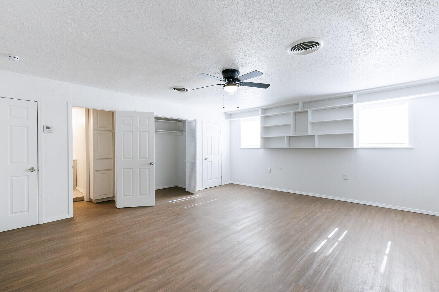 5517 16th Place Lubbock, TX 79416 - Photo 10 of 23 an empty room with wooden floor and windows