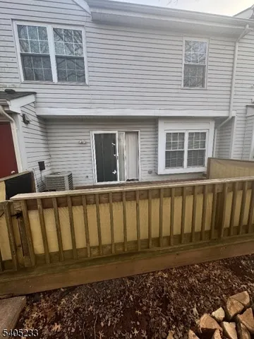 a view of a house with wooden fence
