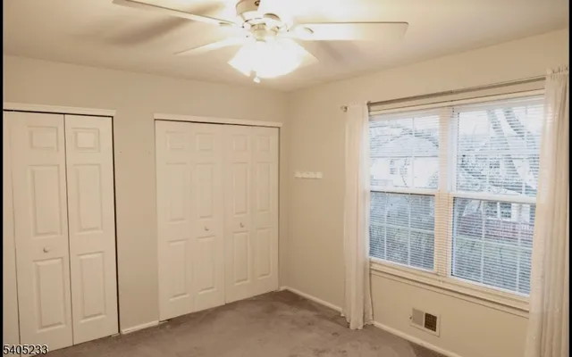 an empty room with windows and closet