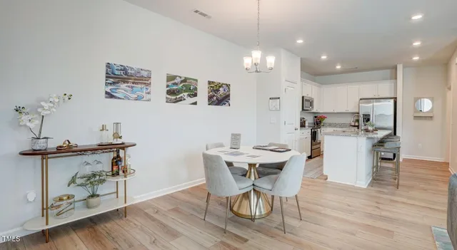 a view of kitchen with kitchen island microwave and wooden floor