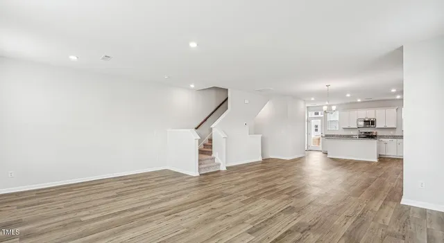 a kitchen with stainless steel appliances granite countertop a refrigerator a stove and a sink