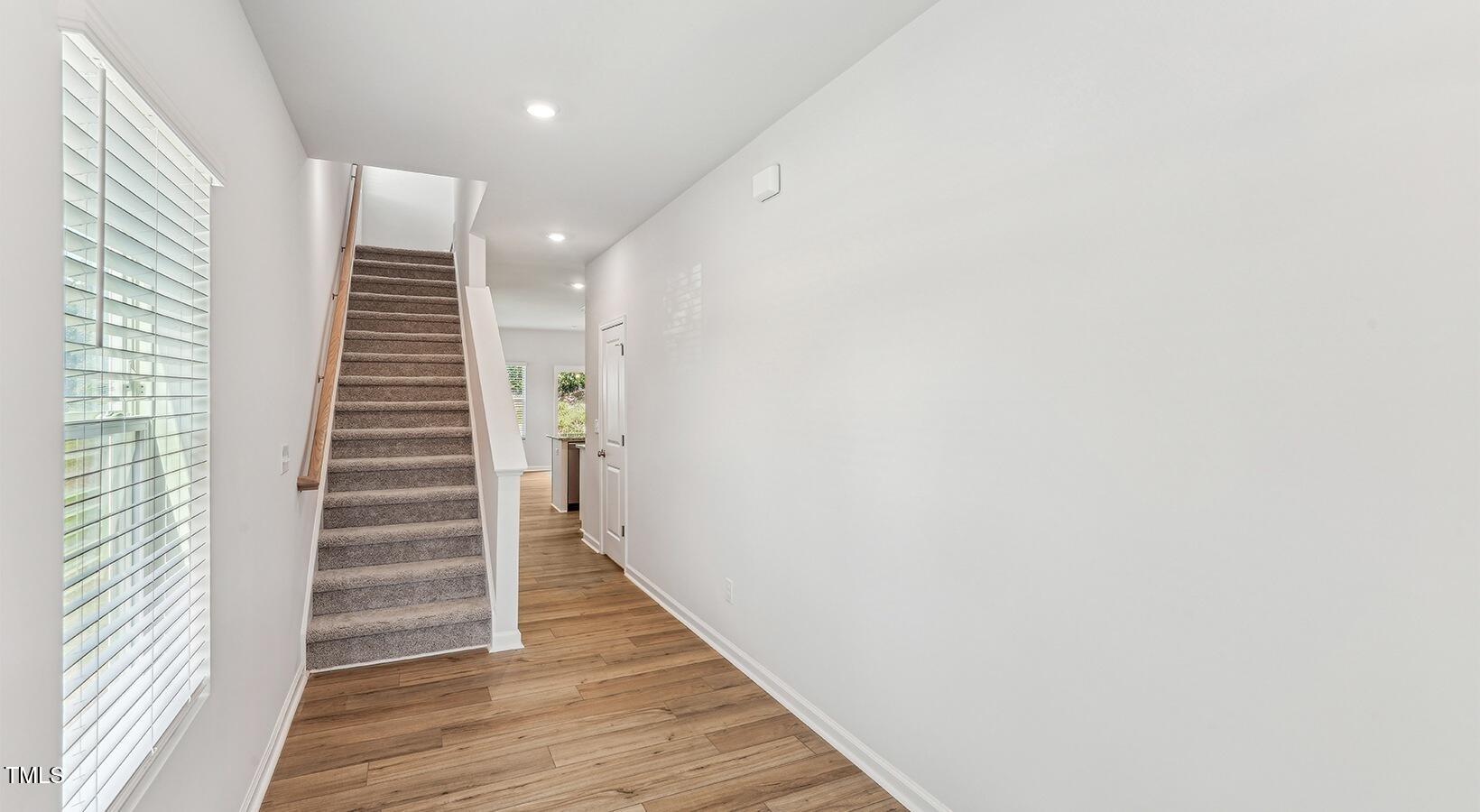 101 Decatur Drive Raleigh, NC 27603 - Photo 16 of 24 a view of a hallway with stairs and wooden floor