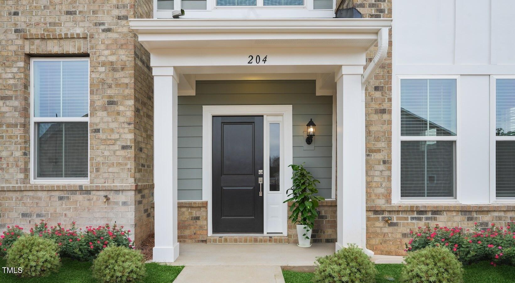 101 Decatur Drive Raleigh, NC 27603 - Photo 19 of 24 a front view of a house with potted plants