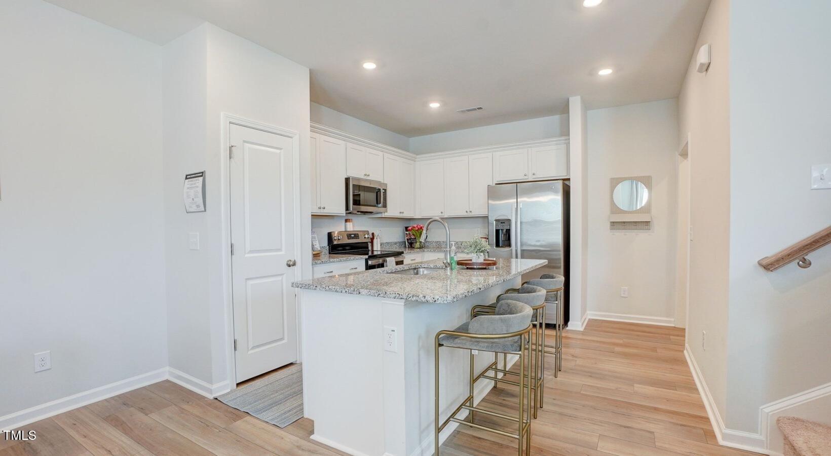 101 Decatur Drive Raleigh, NC 27603 - Photo 21 of 24 a kitchen with kitchen island a sink appliances and cabinets