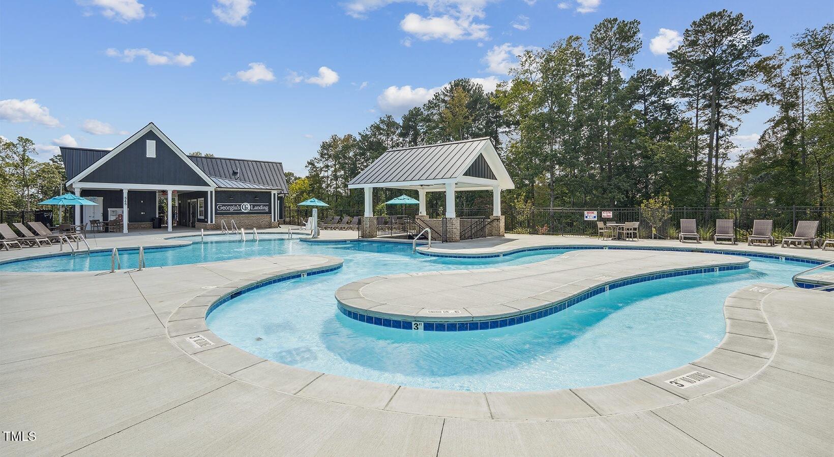 101 Decatur Drive Raleigh, NC 27603 - Photo 3 of 24 a view of a white house with a swimming pool and a chairs