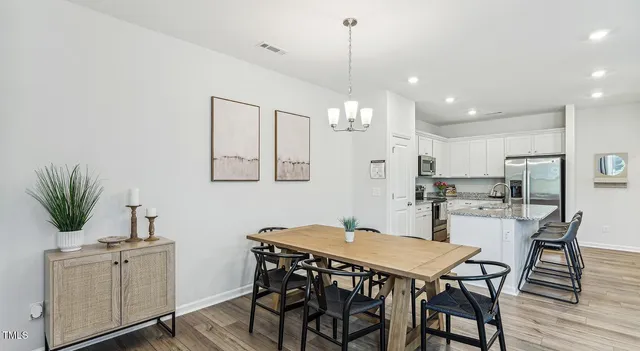 a kitchen with granite countertop a sink a stove and cabinets