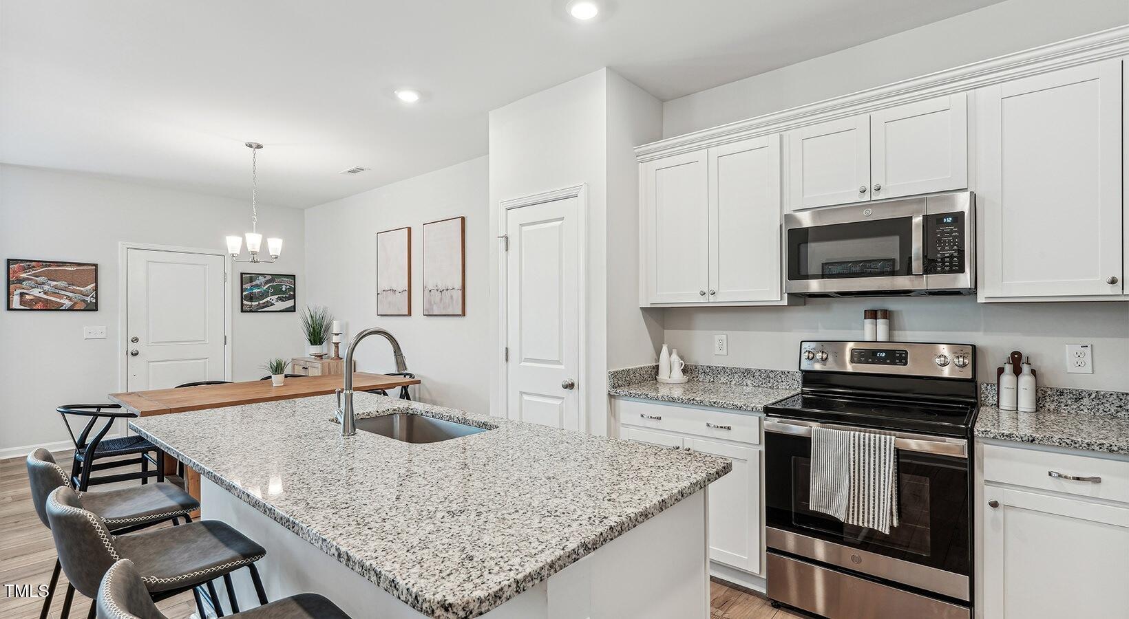 101 Decatur Drive Raleigh, NC 27603 - Photo 10 of 24 a kitchen with granite countertop a sink a stove and cabinets