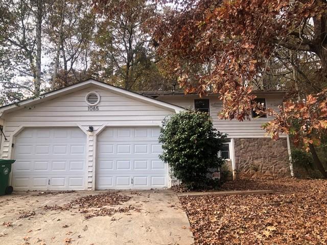 1065 To Lani Farm Road Stone Mountain, GA 30083 - Photo 1 of 1 a front view of a house with a yard
