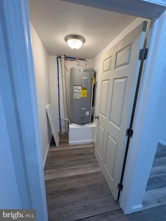 a view of a hallway view with wooden floor and staircase