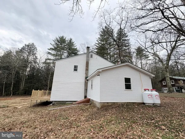 a view of a white house with a yard and garage