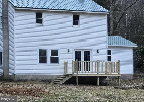 a view of a house with a yard and furniture
