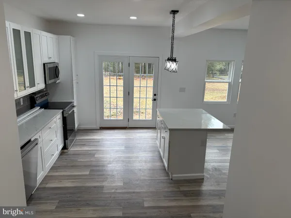 a kitchen with granite countertop a stove and a sink