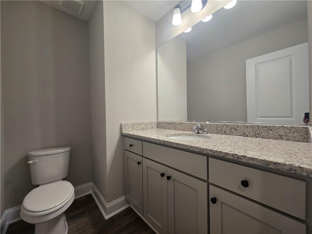 2970 Cannon Bridge Road Demorest, GA 30535 - Photo 17 of 36 a bathroom with a granite countertop toilet sink and mirror