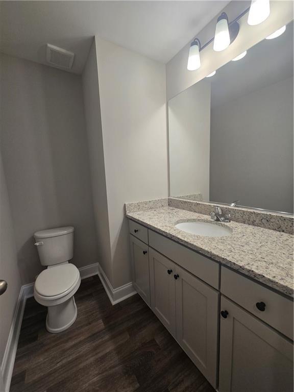 2970 Cannon Bridge Road Demorest, GA 30535 - Photo 18 of 36 a bathroom with a granite countertop toilet a sink and a mirror