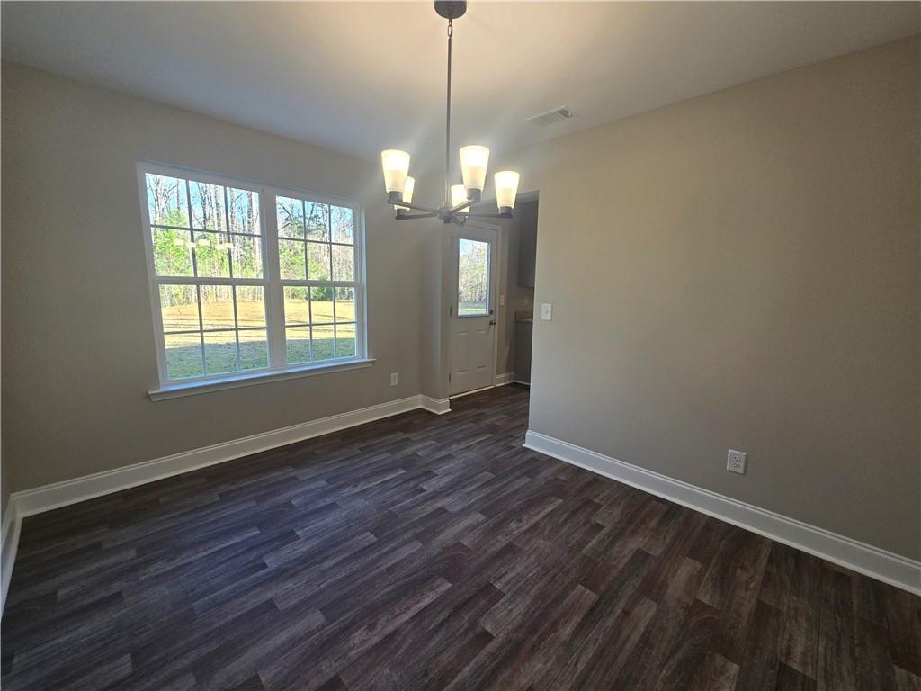 2970 Cannon Bridge Road Demorest, GA 30535 - Photo 7 of 36 a view of an empty room with wooden floor and a window