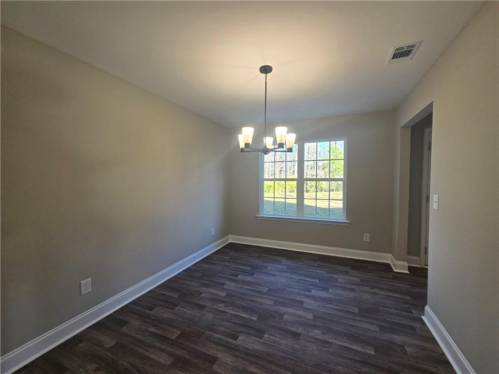 2970 Cannon Bridge Road Demorest, GA 30535 - Photo 8 of 36 an empty room with wooden floor chandelier and windows