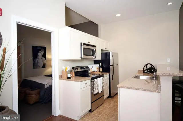 a kitchen that has a sink and a stove in it