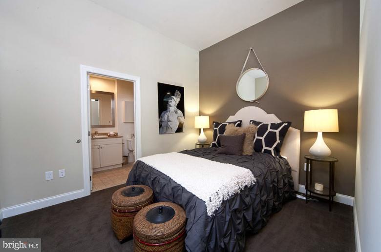 1201 North Charles Street, Unit 2BR Baltimore, MD 21201 - Photo 9 of 19 a bedroom with a bed and wooden floor