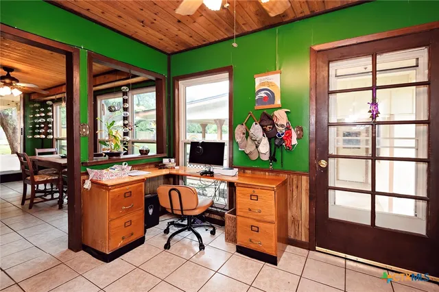 a dining room with furniture water view and a floor to ceiling window