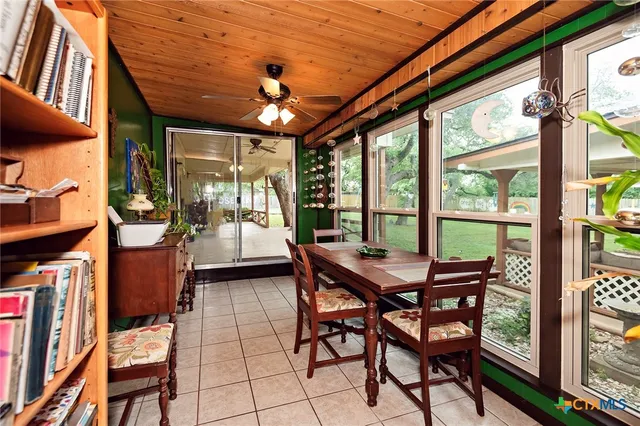 a dining room with furniture and a potted plant