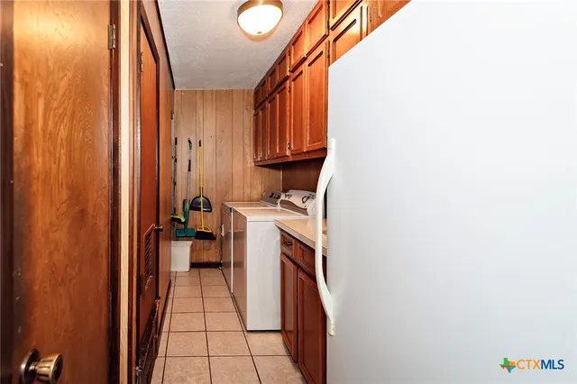 a bedroom with a bed and a flat tv screen on the dresser
