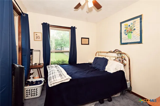 a bath room with a toilet a sink and a mirror