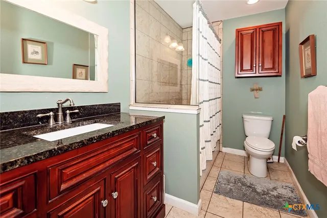 a bedroom with a bed window and flat screen tv