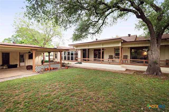a view of outdoor space with deck and yard