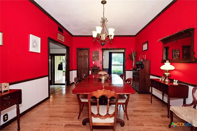 a view of a dining room with furniture and chandelier