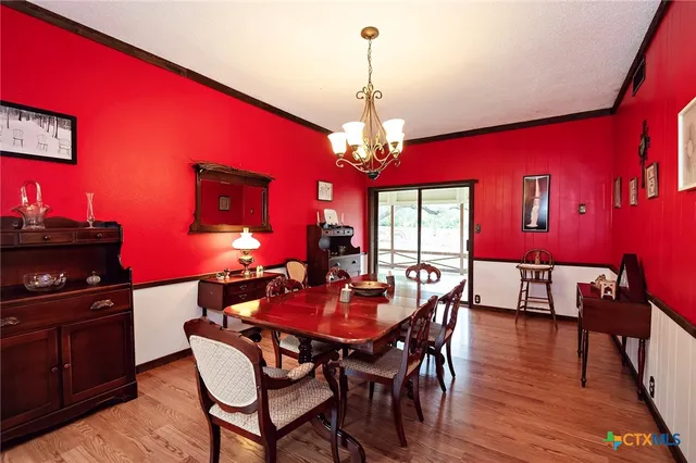 a view of a dining room with furniture and chandelier