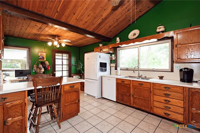 a kitchen with stainless steel appliances kitchen island granite countertop furniture a large window and a sink