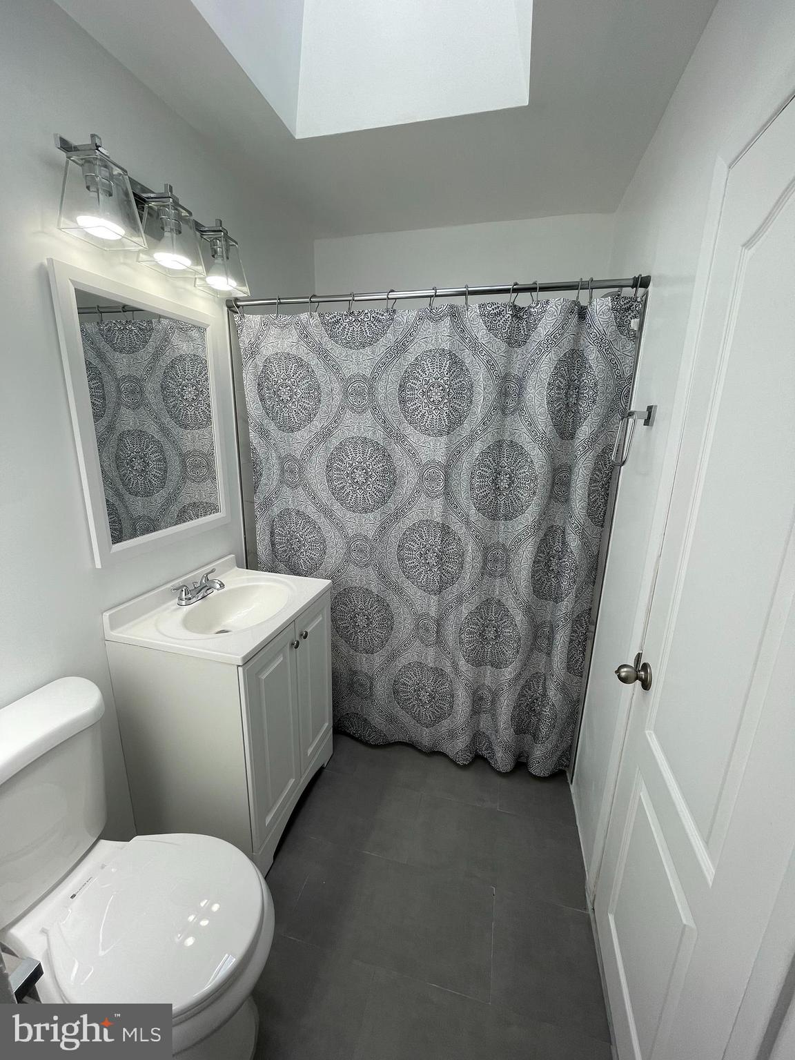 3349 Fairdale Road Philadelphia, PA 19154 - Photo 12 of 20 a white toilet sitting next to a shower curtain