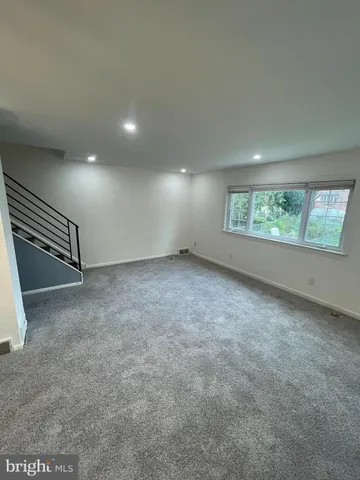 a view of an empty room with white walls