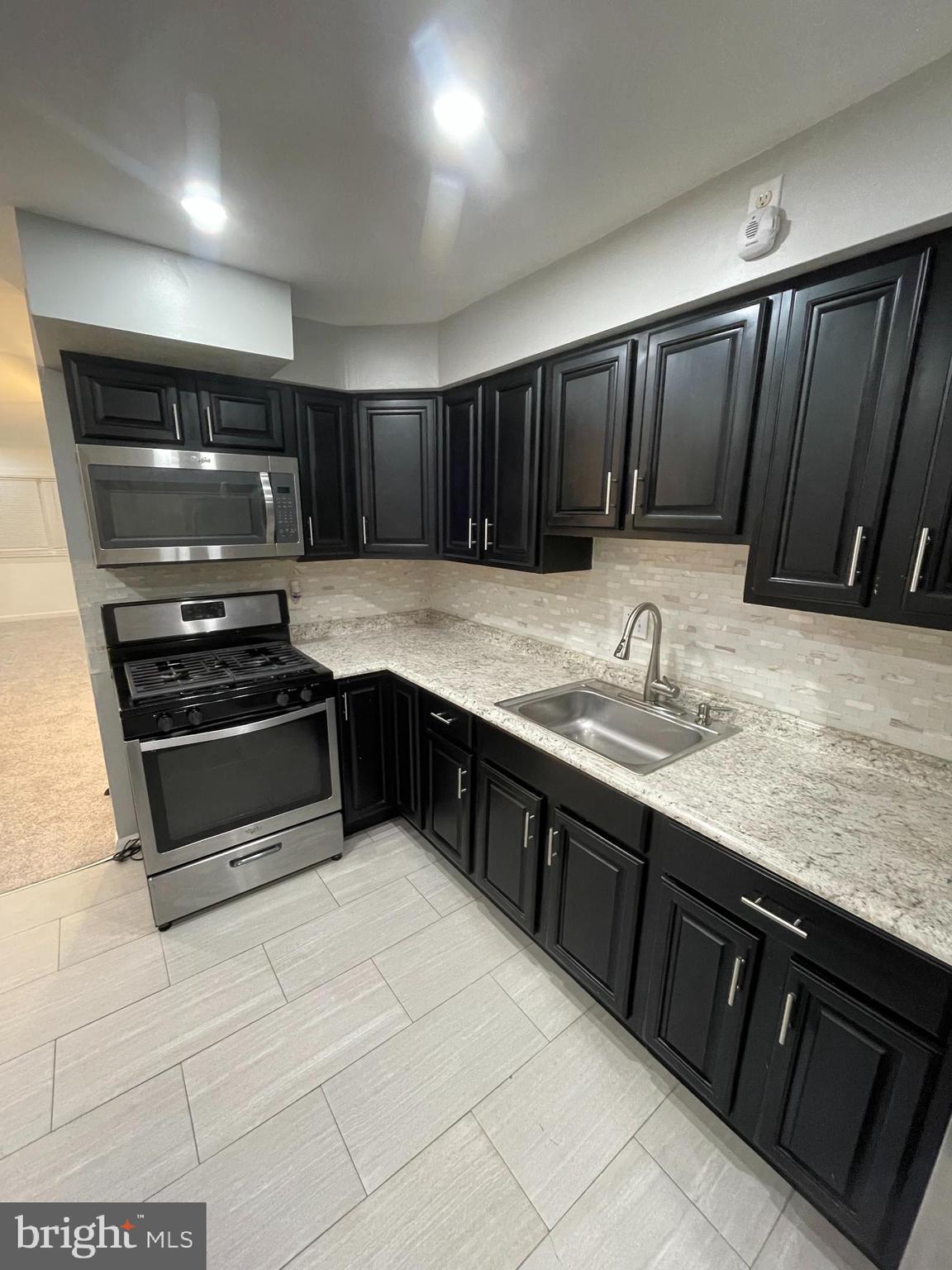 3349 Fairdale Road Philadelphia, PA 19154 - Photo 2 of 20 a kitchen with stainless steel appliances a stove a sink and a microwave