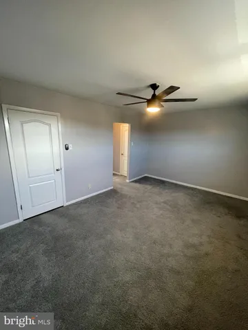 a view of an empty room and a window