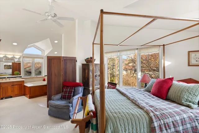 a bedroom with a bed couch and a window