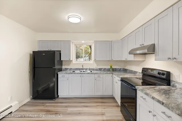 a kitchen with a sink a stove and refrigerator