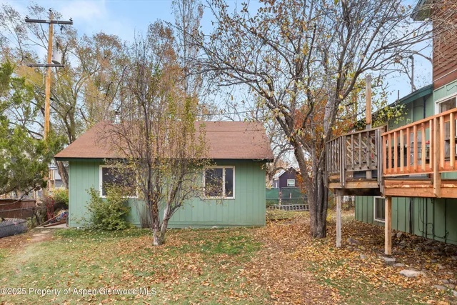 a house that has a tree in front of it