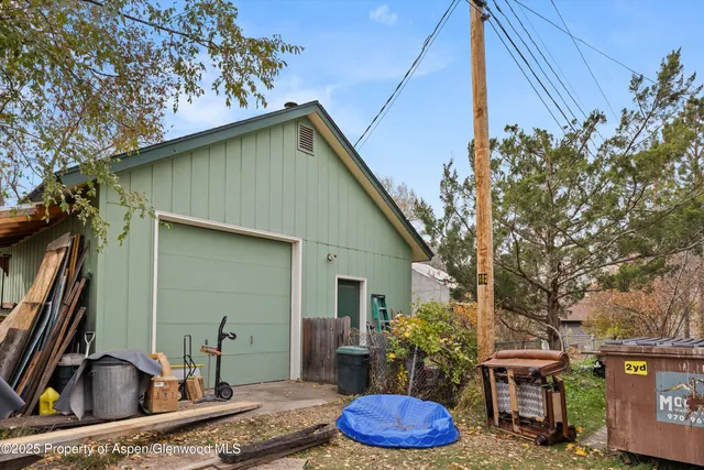 a backyard of a house with plants and outdoor seating