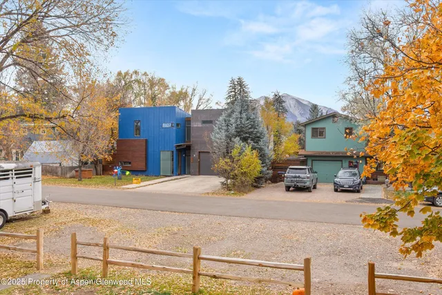 a view of a house with snow on the road