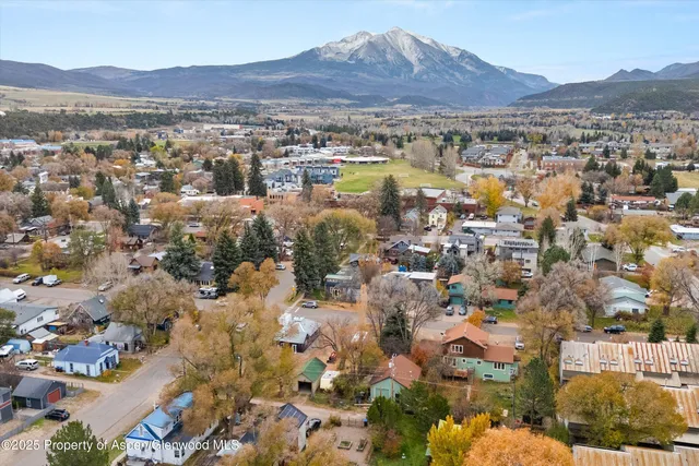 an aerial view of residential house and sandy dunes