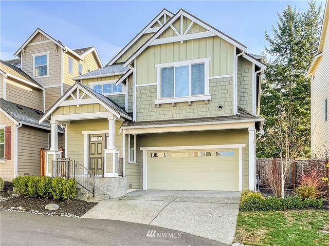 a view of a house with a yard and potted plants