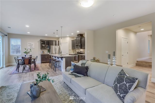 a living room with furniture and kitchen view