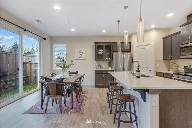 a large kitchen with a table and chairs