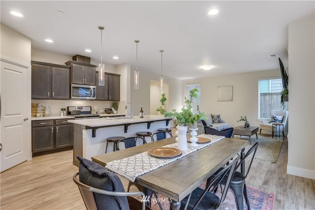 a view of a dining room and kitchen with a table chairs a workspace
