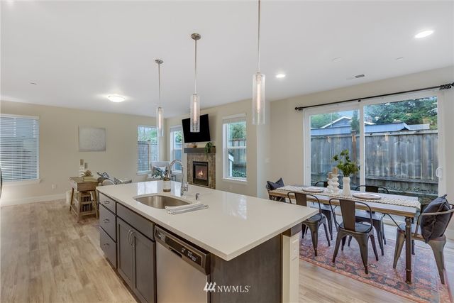 a kitchen with a table chairs stove and kitchen island