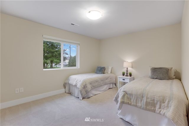 a bedroom with two beds and a window